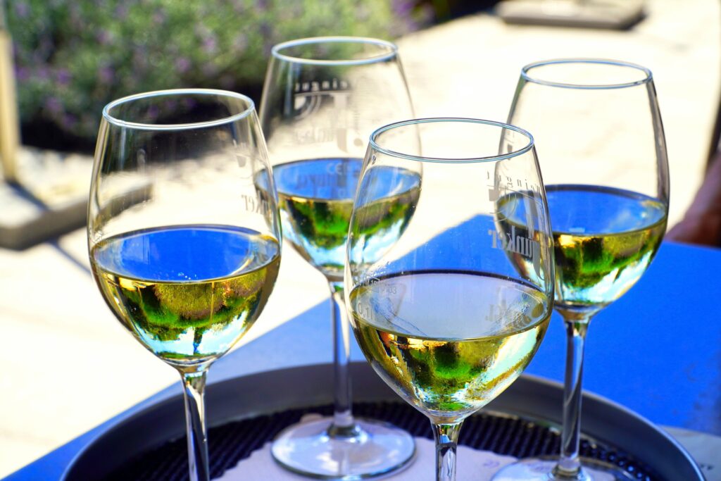 four glasses of white wine served at a Solvang, California wine tasting room
