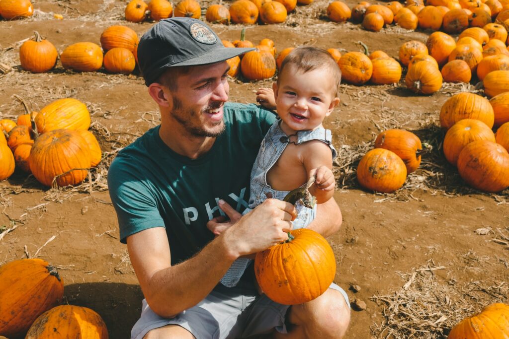 Father and child picking pumpkins at Solvang's Farmer Pumpkin Patch