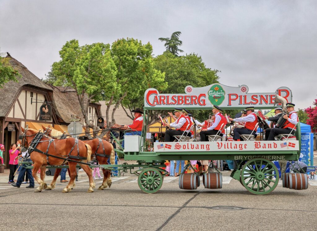 Horse-drawn Carlsberg wagon carrying the Solvang Village Band during the Danish Days parade